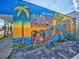 A vibrant mural on a building wall that spells out 