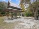A wooden pavilion provides shade and seating near a sandy path in the James E. Grey Preserve at 6329 Alaska Ave, New Port Richey, FL 34653