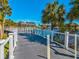Picturesque waterfront walkway with a gazebo, fountain and palm trees on a sunny day at 6329 Alaska Ave, New Port Richey, FL 34653