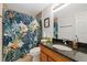 Cozy bathroom featuring a granite vanity and a vibrant floral shower curtain at 6335 Kings Ct, New Port Richey, FL 34653