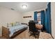 Bedroom with a desk, chair, and daybed provides a comfortable space for work and rest at 6335 Kings Ct, New Port Richey, FL 34653