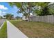 Home exterior with tidy lawn and sidewalk on a sunny day at 6335 Kings Ct, New Port Richey, FL 34653