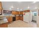 The kitchen features granite counters, tile floors, and wood cabinets providing a functional cooking space at 6335 Kings Ct, New Port Richey, FL 34653