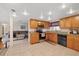 This kitchen includes stainless appliances, granite counters, and access to the living room at 6335 Kings Ct, New Port Richey, FL 34653