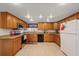 Spacious kitchen with tile floors, ample wood cabinets, modern appliances, and granite countertops for easy cooking at 6335 Kings Ct, New Port Richey, FL 34653