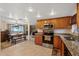 The kitchen showcases an open design with granite counters, stainless steel appliances, and tile flooring at 6335 Kings Ct, New Port Richey, FL 34653