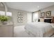 Cozy bedroom featuring carpet flooring, stylish décor, and a bright window at 6770 Pebblebrooke Way, Zephyrhills, FL 33541