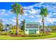 Premium Outlets entrance with tropical palm trees and clear skies at 6770 Pebblebrooke Way, Zephyrhills, FL 33541