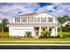 Beautiful two-story home featuring a front yard with palm trees and a two-car garage at 6770 Pebblebrooke Way, Zephyrhills, FL 33541