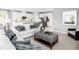 Open-concept living area showcasing a cozy sofa and a view of the modern kitchen at 6770 Pebblebrooke Way, Zephyrhills, FL 33541