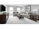 Cozy living room with gray couches, patterned pillows, and a television at 6770 Pebblebrooke Way, Zephyrhills, FL 33541