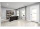 Bright home office with a large desk, shelving, and natural light from two windows at 6770 Pebblebrooke Way, Zephyrhills, FL 33541