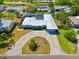 An aerial shot of the property showcasing landscaping, long driveway, and well-maintained exterior at 7230 17Th N Ln, St Petersburg, FL 33702