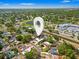An aerial view of a home in a well-treed neighborhood with a lake nearby at 7230 17Th N Ln, St Petersburg, FL 33702