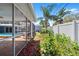 Lush backyard showing the screen lanai and adjacent landscaping at 7230 17Th N Ln, St Petersburg, FL 33702