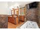 Bathroom with stone vessel sinks, wooden cabinets, brown tile and a large tub at 7230 17Th N Ln, St Petersburg, FL 33702