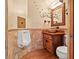 Bathroom featuring unique stone sink, wooden cabinet and artistic tree wall design at 7230 17Th N Ln, St Petersburg, FL 33702