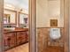 Rustic-style bathroom featuring double stone sinks, wooden cabinets, and a urinal at 7230 17Th N Ln, St Petersburg, FL 33702