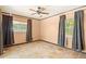 Bedroom featuring a ceiling fan and neutral walls with tiled floors and window views at 7230 17Th N Ln, St Petersburg, FL 33702