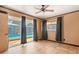 Bedroom featuring a ceiling fan and neutral walls with tiled floors and patio access to the pool at 7230 17Th N Ln, St Petersburg, FL 33702