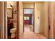 Hallway view into bathroom and bedroom with brown tile flooring at 7230 17Th N Ln, St Petersburg, FL 33702