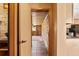 Hallway with wood paneled walls, leading to the kitchen and the main bedroom at 7230 17Th N Ln, St Petersburg, FL 33702