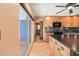 View of the kitchen with wood cabinets and dark countertops, as well as access to an exterior patio at 7230 17Th N Ln, St Petersburg, FL 33702