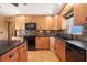 Updated kitchen with wooden cabinets, black appliances, tile backsplash and a matching island at 7230 17Th N Ln, St Petersburg, FL 33702