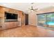 Spacious living room features custom built-in entertainment center and sliding glass doors to pool area at 7230 17Th N Ln, St Petersburg, FL 33702