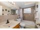Bathroom featuring a tiled shower and backsplash, framed mirror, and neutral tones at 7341 Bimini Dr, Port Richey, FL 34668