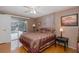 Bedroom boasts pool access, neutral colors, and a comfortable, patterned bedspread at 7341 Bimini Dr, Port Richey, FL 34668