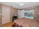 Bedroom featuring a sliding door to the pool, tile floors, and a full bed at 7341 Bimini Dr, Port Richey, FL 34668