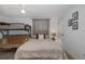 Bright bedroom with bunk bed features a comfortable bed and neutral colors at 7341 Bimini Dr, Port Richey, FL 34668