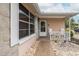 Charming entrance showcasing a tiled walkway, covered porch, and textured exterior at 7341 Bimini Dr, Port Richey, FL 34668