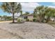 Charming home featuring mature landscaping, a gravel front yard, and well-maintained exterior at 7341 Bimini Dr, Port Richey, FL 34668