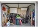 Garage space containing cabinets, golf clubs, bicycles, chairs, and yard tools at 7341 Bimini Dr, Port Richey, FL 34668