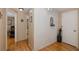 Hallway view showcasing the hardwood floors, white brick accent wall, and access to various rooms, creating seamless flow at 7341 Bimini Dr, Port Richey, FL 34668