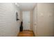 Bright hallway featuring hardwood floors, neutral walls, and stylish decor elements, enhancing the home's charm at 7341 Bimini Dr, Port Richey, FL 34668