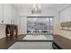 Bright kitchen with white cabinets and sink has pool view from window at 7341 Bimini Dr, Port Richey, FL 34668
