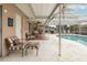 Cozy enclosed pool and patio with comfortable seating, perfect for relaxing and entertaining at 7341 Bimini Dr, Port Richey, FL 34668