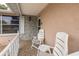 Close-up of the front porch with seating, offering a cozy and inviting outdoor space at 7341 Bimini Dr, Port Richey, FL 34668