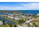 Aerial view showing a waterfront community with condos, townhomes, boat docks, and water views at 8211 Brent St # 837, Port Richey, FL 34668