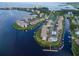 An aerial perspective of a waterfront neighborhood with condos, docks, boats, and a pool at 8211 Brent St # 837, Port Richey, FL 34668