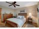 Cozy bedroom with wooden furniture, textured walls, and a ceiling fan, providing a relaxing retreat at 8211 Brent St # 837, Port Richey, FL 34668