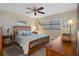Comfortable bedroom featuring a wood-accent wall, ceiling fan, and natural light, creating a cozy atmosphere at 8211 Brent St # 837, Port Richey, FL 34668