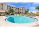 Beautiful community pool is surrounded by well-kept hedges and offers plenty of lounge chairs for relaxing at 8211 Brent St # 837, Port Richey, FL 34668