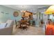 Cozy dining area adjacent to kitchen, featuring a round wooden table and seating for four at 8211 Brent St # 837, Port Richey, FL 34668