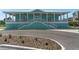 A light blue condo building with a porch is visible on the front of the unit, with a landscaped yard at 8211 Brent St # 837, Port Richey, FL 34668