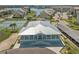 An aerial view of a light blue condo building with tennis courts, boat parking, and covered car parking at 8211 Brent St # 837, Port Richey, FL 34668
