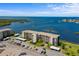 Aerial view of a beachfront condo building, showcasing its architecture and waterfront location with adjacent parking at 8211 Brent St # 837, Port Richey, FL 34668